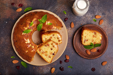 Round biscuit cake with almond nuts, raisins and dried cranberries. Delicious homemade dessert.