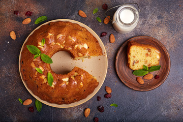Round biscuit cake with almond nuts, raisins and dried cranberries. Delicious homemade dessert.