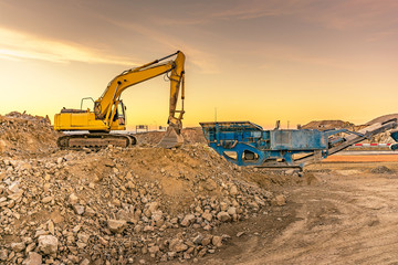 Excavator collecting stone in an open-cast mine