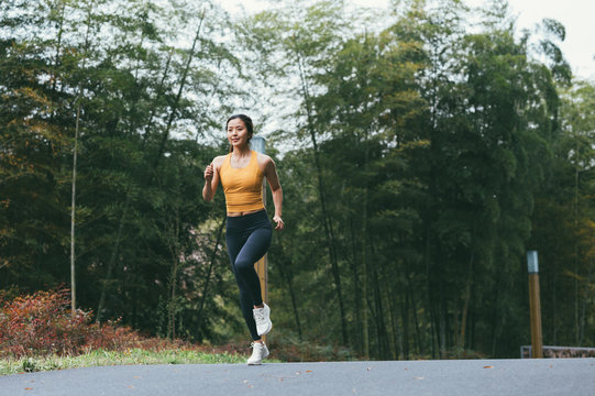 young asian beauty woman running outdoors