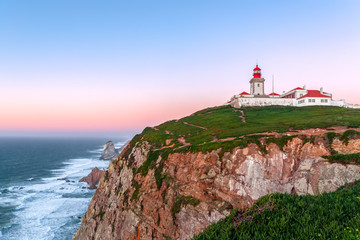 Fototapeta na wymiar Cabo da Roca, Sintra, Portugal. Lighthouse and cliffs over Atlantic Ocean, the most westerly point of the European mainland at sunset.