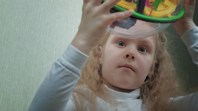 Little girl play with three-dimensional toy puzzle