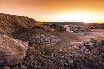 Excavator collecting stone in an open-cast mine