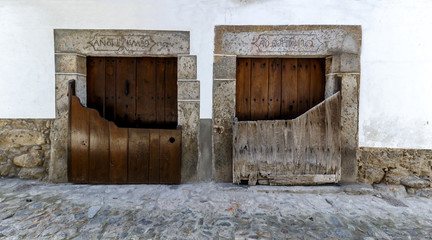 Popular architecture in Candelario. Spain.  View of entrance of the houses with its “Batipuerta”, half door made of wood which stopped the animals or snow from getting inside the houses.