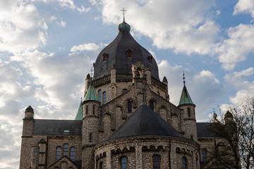 Partial view of the frontside of the 19th century St Lambertus church (english St Lambertus) with a spectacular view on the dome with dramatic clouds