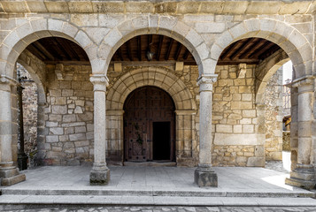 Entrance door and main facade of ancient church in San Martín del Castañar. Sierra de Bejar. Salamanca. Spain. UNESCO World Heritage site.