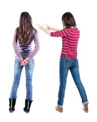 Back view of two pointing girl in sweater.