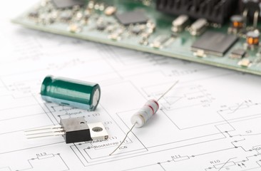 Transistor, resistor and capacitor electronic parts or components in front of pcb board with pcb...