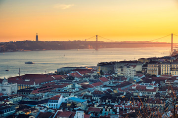 View from the top of the panorama of the city of Lisbon Tejo River and the Bridge on April 25 at sunset.