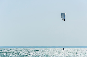 Person kitesurfing on a beach on the island of Mallorca, Mediterranean Sea
