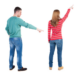 Back view of couple in sweater pointing.