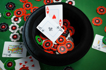 Aces and chips in a hat on the poker table