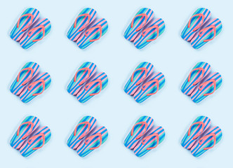 Obraz premium Summer colorful flip flop pattern on blue background. Beach vacation concept
