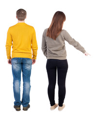 Back view of couple in sweater pointing.