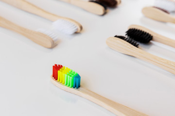 Pride concept. Rainbow and another colorful bamboo toothbrushes. Close-up, top view. Natural organic product for oral hygiene. Dental zero waste and no plastic concept. Safe for the earth.