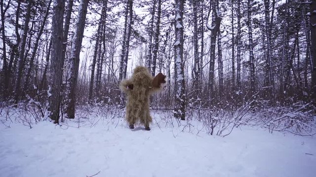 the hairy shaman dances with a tambourine in the winter forest