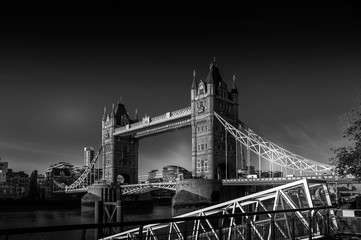 Fototapeta na wymiar Black and white dramatic photo of the Tower Bridge in the London United Kingdom