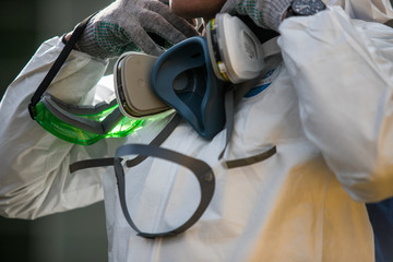 closeup man face in respirator and glasses
