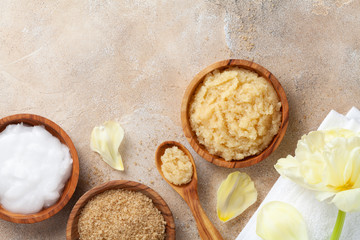 Sugar body scrub with ingredients on stone table. Homemade cosmetic for spa.