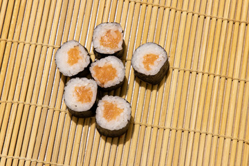 maki rolls with salmon with traditional Asian cuisine delicious dish food photography simple background wooden carpet table