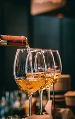 Küchenrückwand glas motiv bartender pouring white wine into a glass in cafe or bar © pavel siamionov