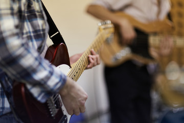 Musicians plays electric guitars during a practice session