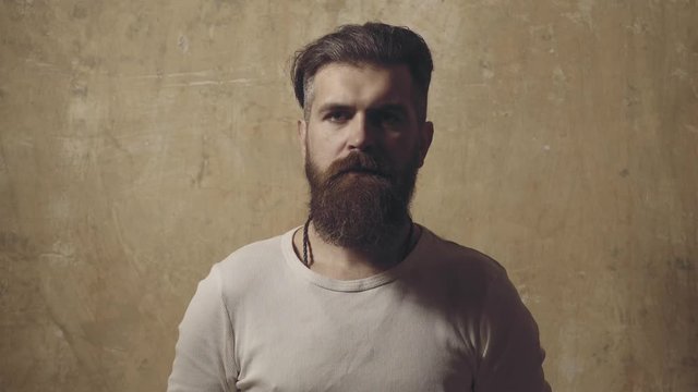Man comb his hair on wall background. Hair Stylist and Barber. Bearded hipster man with long beard and mustache. Barbershop Barbers and Barber salon. Portrait of stylish man beard.