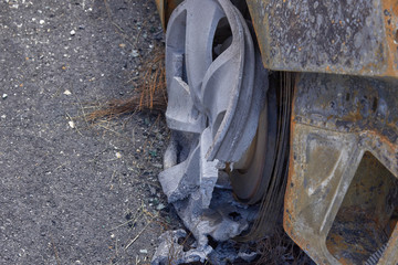 wheels and wheels of a burned-out car in one of the city's districts