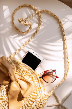 Top View Of Summer Bag , Smart Phone And Sunglasses On White Color Background, Travel Concept. Flat Lay , Copy Space