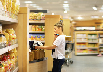 Woman choosing a dairy products at supermarket	
