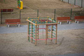 Playground is closed for quarantine, the playground is blocked by a red warning tape, children cannot play on the street