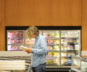 Man choosing frozen food from a supermarket freezer	