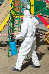 Man in hazmat suit cleaning and disinfecting coronavirus cells epidemic MERS-CoV virus disinfect protection concept 2019-nCoV pandemic health risk