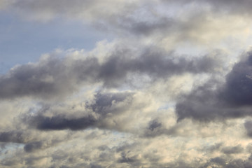 Fototapeta na wymiar low-floating Cumulus clouds at dawn against a blue sky
