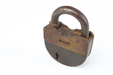 Vintage padlock. An old rusty key lock securely locking the door. Padlock on a white background. Collecting old things. Locking doors. Ancient padlock. Securing property. Close. Metal key lock.