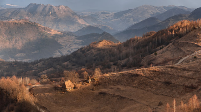 Warm Winter In Romania. Dumesti, Alba, West Romanian Mountains ( Muntii Apuseni ). Beautiful Morning Rural Landscape With Lonely Thatched Hut Amid Numerous Hills And Mountains Transylvanian Pastoral
