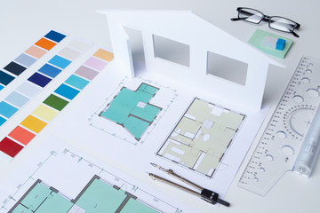 Fototapeta na wymiar Concept - the desktop of an interior designer. The choice of color for the facade. The choice of colors. The office of the architect. Work on the facade of the house. Layout of the building.