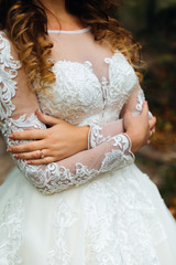 close-up of wedding dress on the bride who embrace himself