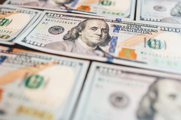 American cash dollars close-up. One Hundred Dollar Banknotes. Soft focus image.