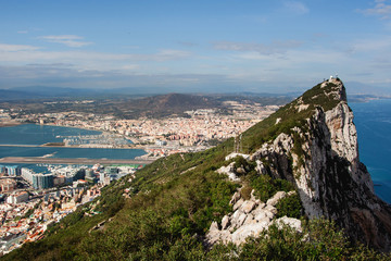 Fototapeta na wymiar Rock of Gibraltar top view. High mountain over the sea. Sunny cityscape background. British territory landscape. Harbour coastal city panoramic view.