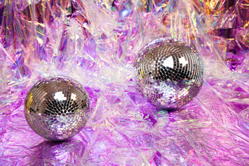 Two Disco balls on the floor with cellophane refelective paper backdrop for fancy party theme
