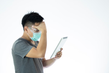 man surgical mask seriously reads news form tablet corona virus covid19 outbreaks contagious disease