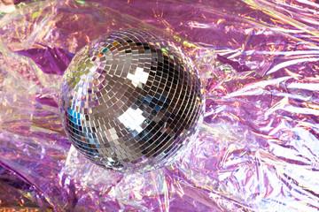 Shiny Disco ball on the floor with cellophane refelective paper backdrop for fancy party theme