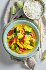 Yummy yellow curry with chicken, vegetables and rice
