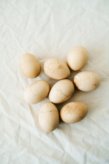 Fototapeta premium Seven Easter eggs trendy pastel colored with cracks lie on the table on a light tablecloth. top view. minimal style. easter concept.copy space for text