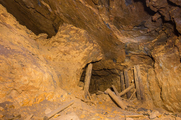 Abandoned underground bauxite mine tunnel with ore pillar