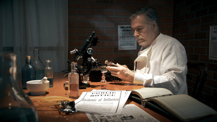 A medical researcher during the 1918 influenza pandemic working in his private laboratory searching for a cure for Spanish Flu.