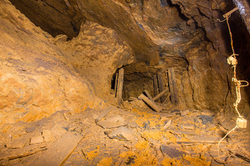 Abandoned underground bauxite mine tunnel with ore pillar