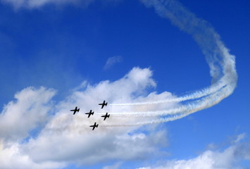 airplane in formation in the bright blue sky and clouds