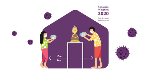 SONGKRAN, Thailand Water Festival 2020, year of COVID-19 which people should stay at home and practice social distancing to stop the outbreak, people sprinkle water onto a Buddha image at home.